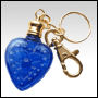 Blue glass heart shaped bottle with Golden key chain cap. Capacity : 4ml (1/7oz)