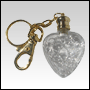 Clear white heart shaped bottle with Golden key chain cap. Capacity: 1/7 oz 