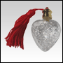 Clear white heart shaped bottle with Red tasseled Gold cap. Capacity:1/7 oz   