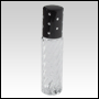 Clear glass swirl design roll on bottle with black cap. Black cap with silver dots.  Capacity: 9 ml 
