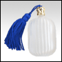 Fluted Pillow shaped White glass perfume bottle with Blue tasseled Gold cap. Capac