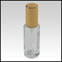 Cylindrical clear glass tall bottle with Gold treatment pump and cap. Capacity: 30 ml (1 oz)
